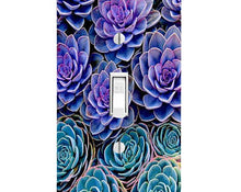 Load image into Gallery viewer, Blue Purple Succulents Light Switch Cover: a photorealistic image of succulents. The top 2/3rds of the cover is filled with large, purple rosette-shaped succulents. The bottom 1/3rd is filled with multiple blue rosette-shaped succulents.
