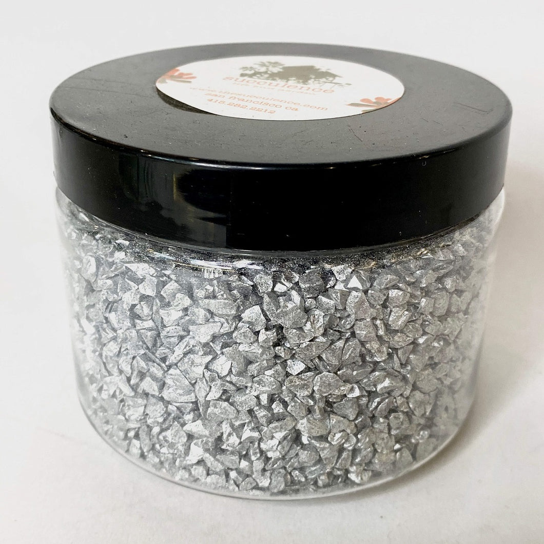 Silver Colored Ice: a full jar holds many small, silver tumbled rocks.