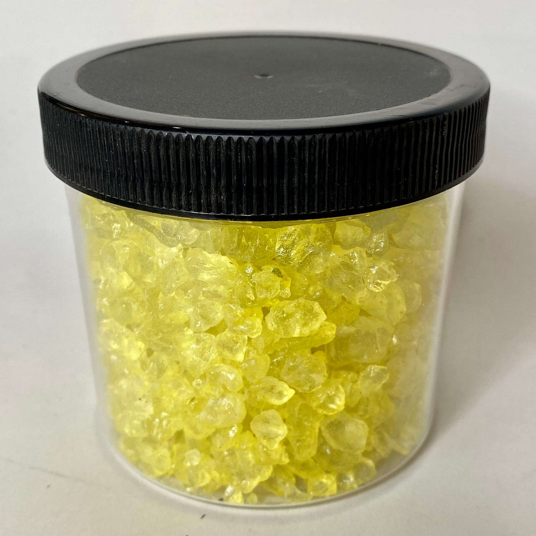 Yellow Colored Ice: a full jar holds many small, yellow tumbled rocks which are translucent.