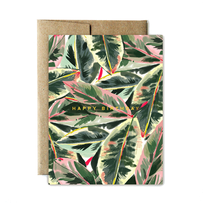 The front of this card depicts a pattern of variegated rubber tree leaves, which are blue-green in the center with creamy-white or rosy-pink margins. Gold foil text across the center reads: 