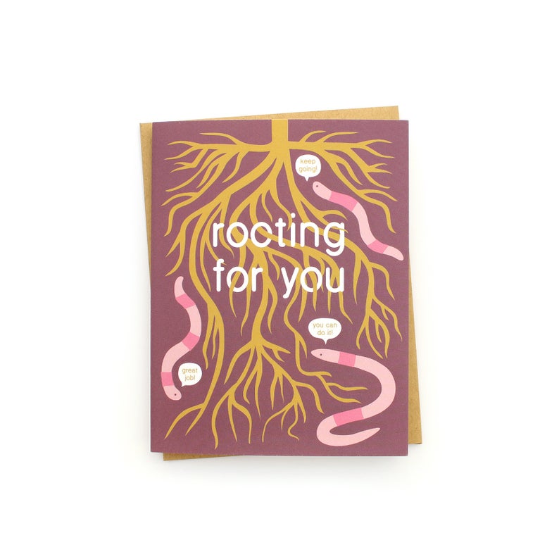 The front of this card depicts an illustrated root system snaking down from the top of the card, which fills out the front of the card. Three pink earthworms live throughout the card, and each of them have speech bubbles saying encouraging things: 