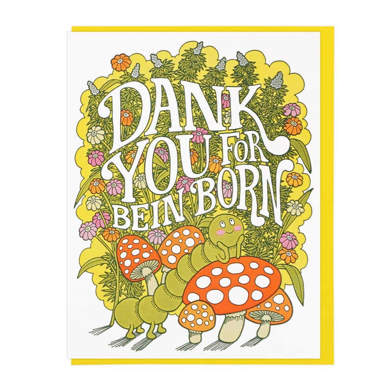 The card depicts a cutesy cartoony caterpillar leaning on a red mushroom. Behind the caterpillar are tall, flowering marijuana plants. Text across the marijuana plants reads: 