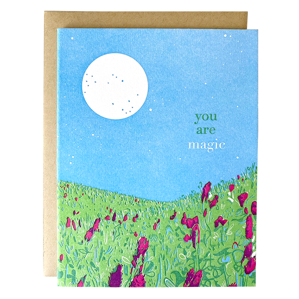 The front of this card depicts a meadow of violet flowers at night, with a bright white moon shining in the upper left corner. Text in the space to the right under the moon reads: 
