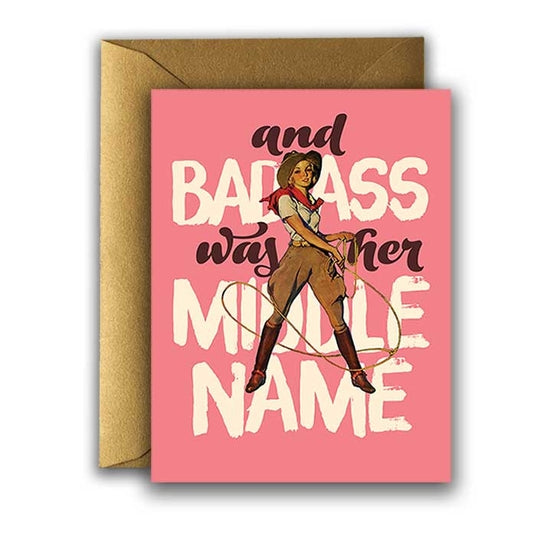 Image of a greeting card, behind which is a gold envelope. The central image on the greeting card is of a retro cowgirl on a pink background. Behind her, partially concealed (but still legible) by the woman, is text reading: 