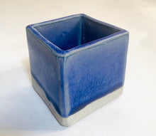Load image into Gallery viewer, A cube planter with a predominantly blue glaze with lavender undertones.
