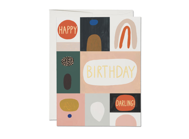 The front of this birthday card is separated into various colorful boxes, within which are minimalist shapes and patterns. The phrase 