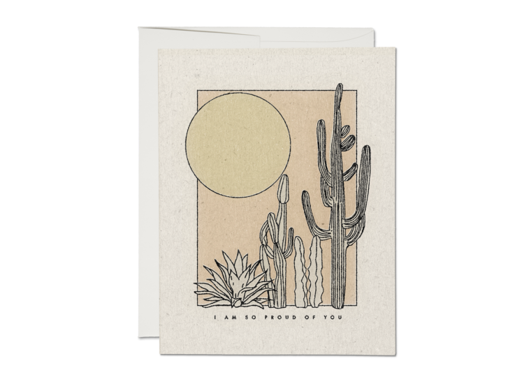 The front of this greeting card depicts a minimalist desertscape with multiple cacti and an agave. The sun shines in the background, and small text beneath the scene reads: 