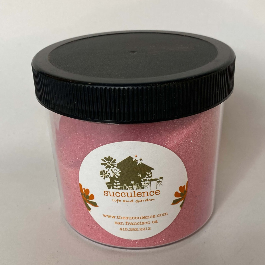 Rose Sand: a full lidded jar holds sparkling, rosy pink sand.