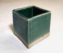 Load image into Gallery viewer, A cube planter in a glazed blue-green color. The bottom 1/8th of the planter is unglazed and retains its natural clay coloring.
