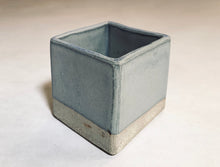 Load image into Gallery viewer, A cube planter in a glazed light blue color. The bottom 1/4th of the planter is unglazed and retains its natural grey clay color.

