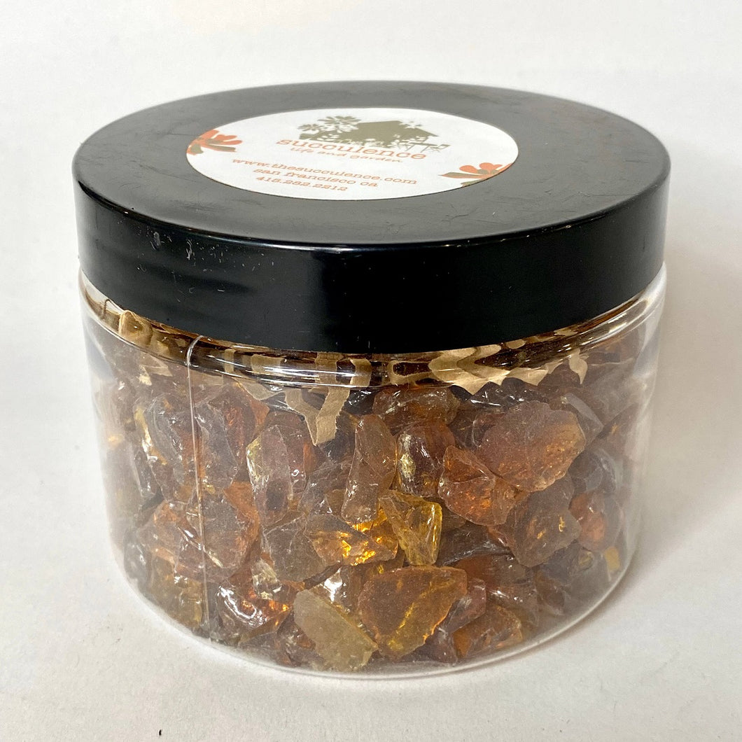 Amber Tumbled Glass: a lidded jar full of amber-colored tumbled glass pieces.